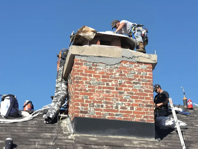 Maple Heights Chimney Sweep installing a custom chimney crown in Maple Heights, OH