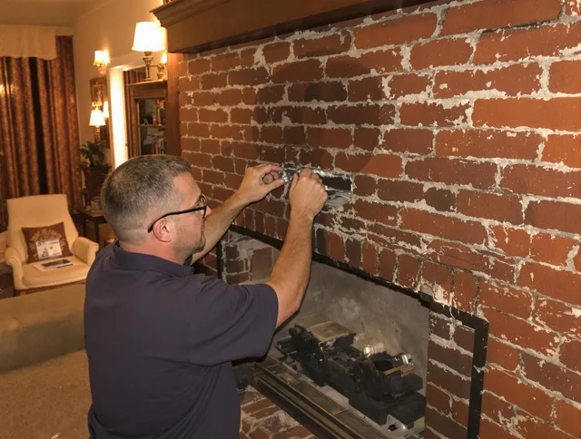 Maple Heights Chimney Sweep expert fixing a fireplace in Maple Heights, OH